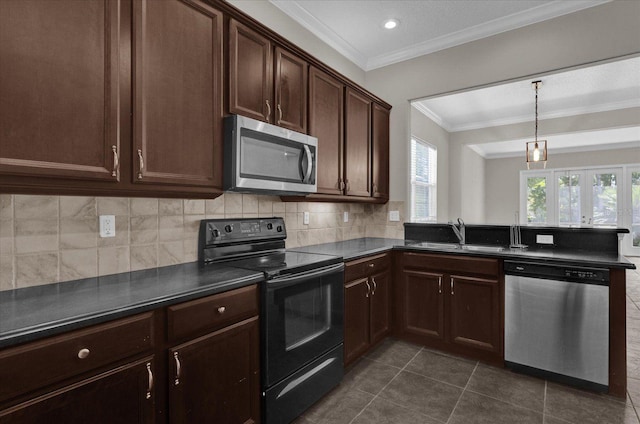 kitchen with ornamental molding, stainless steel appliances, dark tile patterned flooring, and sink