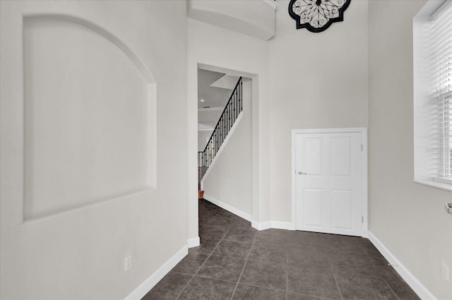 hallway with dark tile patterned flooring