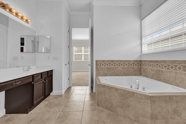 bathroom with ornamental molding, tiled bath, vanity, and tile patterned floors