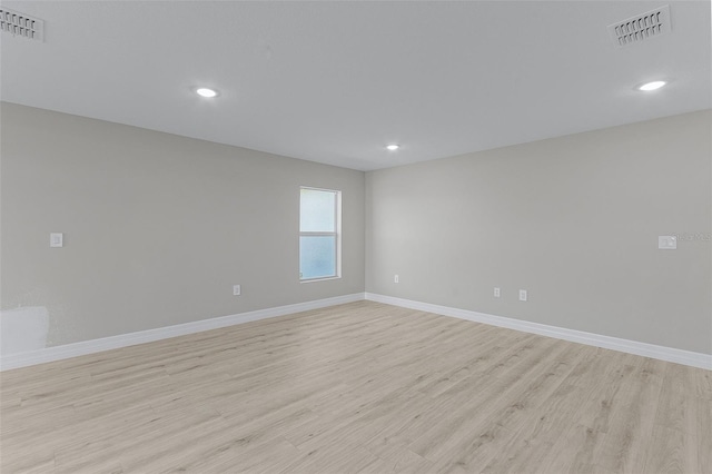 empty room with light hardwood / wood-style floors