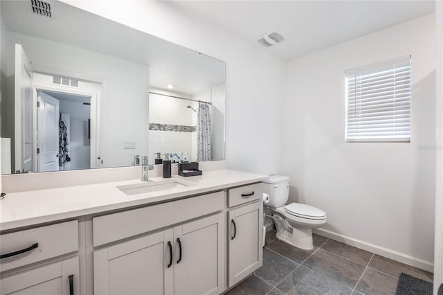 bathroom with vanity, toilet, and walk in shower