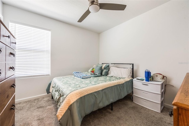 carpeted bedroom with multiple windows and ceiling fan