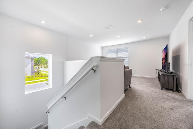 hall featuring light colored carpet