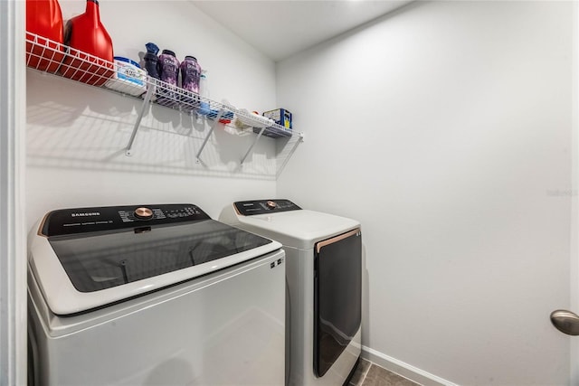 laundry room featuring tile patterned flooring and washing machine and dryer