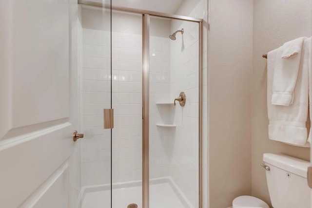 bathroom with toilet and walk in shower