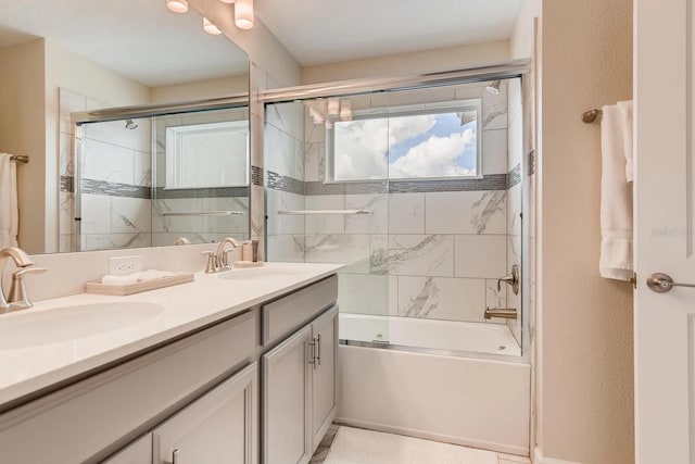 bathroom with vanity and shower / bath combination with glass door