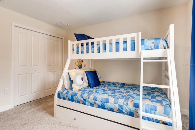 carpeted bedroom featuring a closet