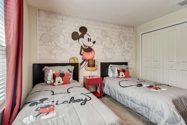 carpeted bedroom with multiple windows and a closet