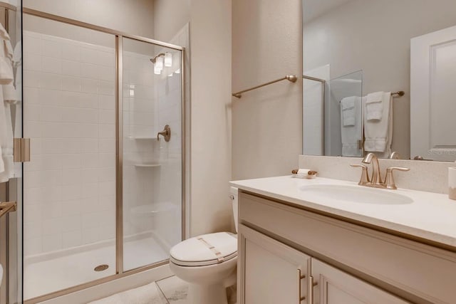 bathroom with toilet, an enclosed shower, and vanity