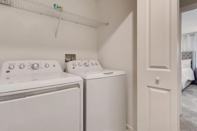 laundry area featuring separate washer and dryer and carpet floors