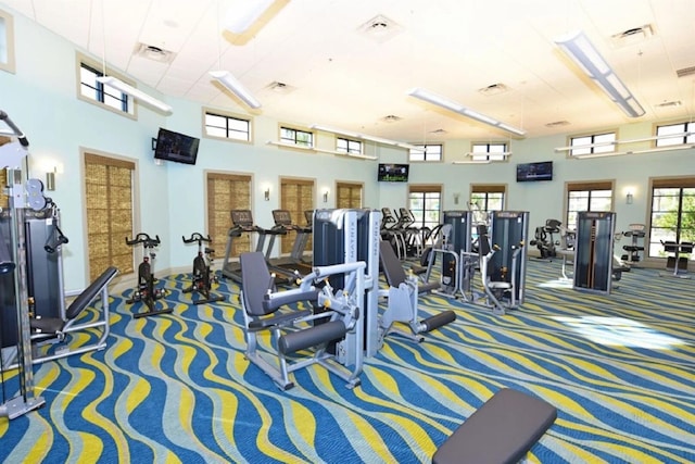 exercise room with a towering ceiling