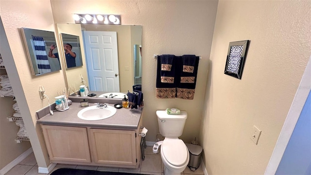 bathroom featuring vanity, toilet, and tile patterned floors