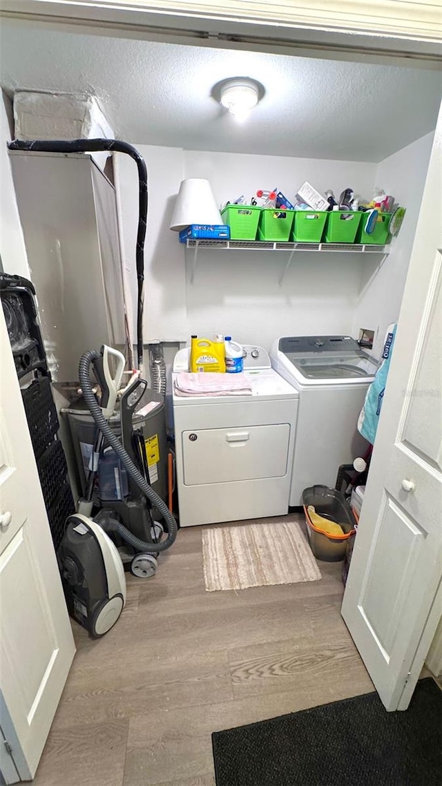 laundry room featuring independent washer and dryer and light wood-type flooring