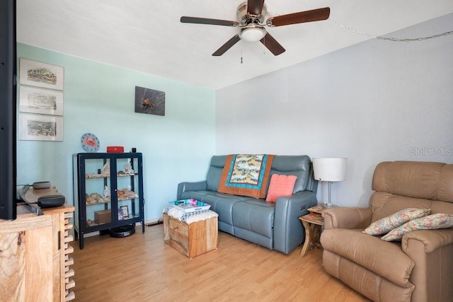 living area with light wood-type flooring and a ceiling fan