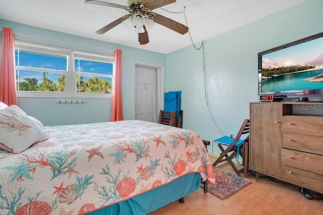 bedroom with a ceiling fan and wood finished floors