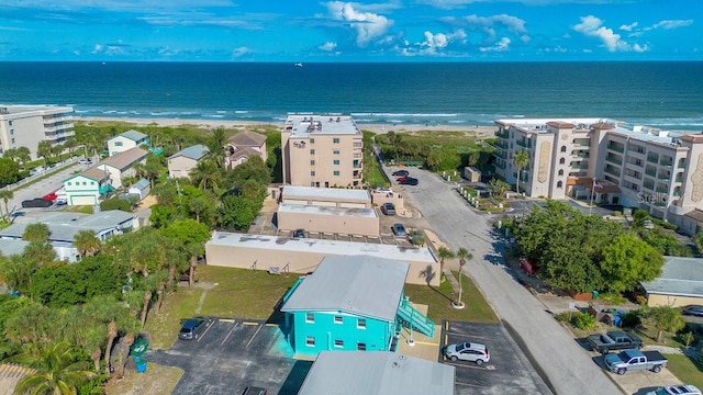 drone / aerial view featuring a water view and a beach view