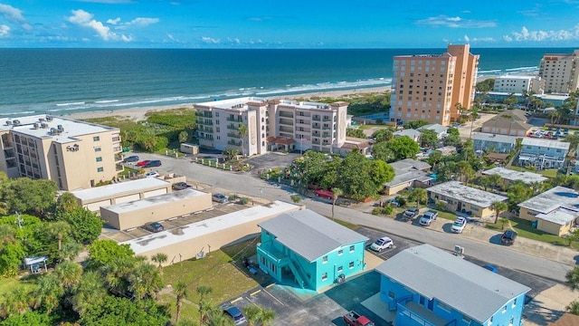 bird's eye view featuring a water view and a beach view