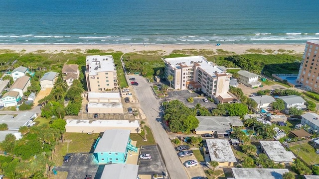 birds eye view of property with a water view and a view of the beach