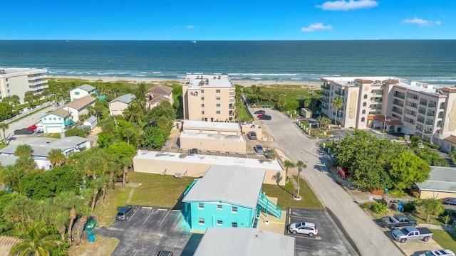 bird's eye view featuring a water view and a beach view