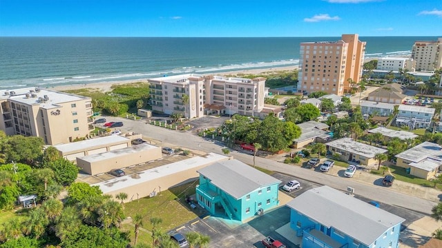 drone / aerial view featuring a beach view and a water view