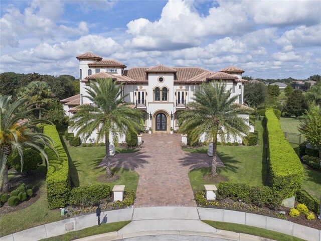 mediterranean / spanish home featuring a front yard