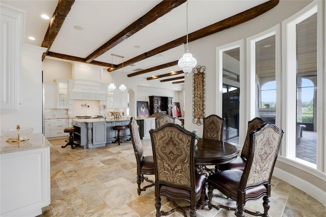 dining space with beam ceiling