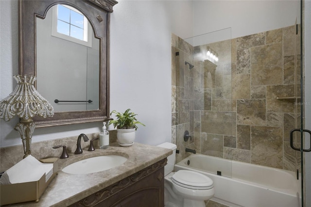 full bathroom with enclosed tub / shower combo, vanity, and toilet