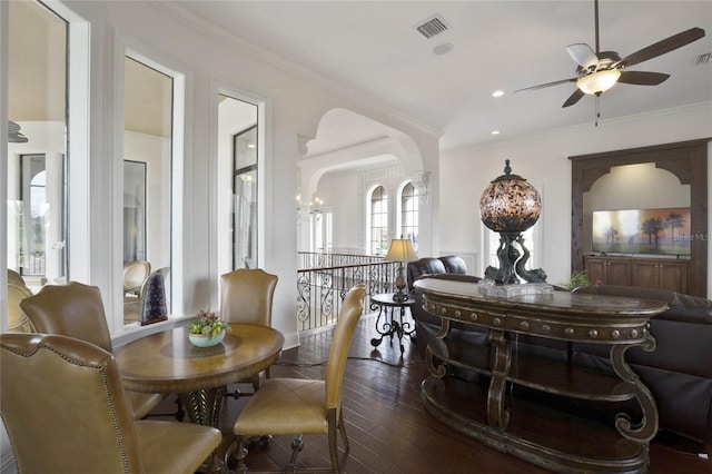 dining room featuring ceiling fan with notable chandelier, dark hardwood / wood-style floors, and ornamental molding