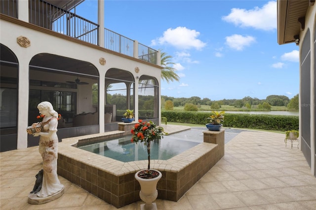 view of patio featuring ceiling fan and a balcony