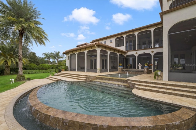 view of pool with an in ground hot tub, a sunroom, and a patio