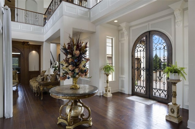 foyer entrance with a high ceiling, plenty of natural light, and french doors