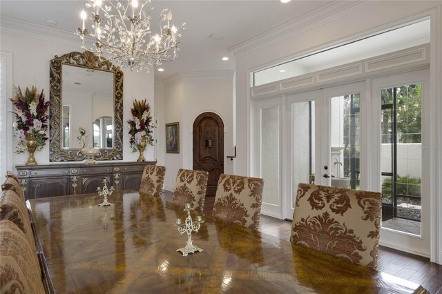 dining area with ornamental molding, a chandelier, and dark hardwood / wood-style flooring