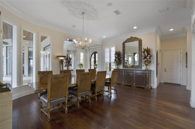 dining room featuring ornamental molding, a chandelier, and dark hardwood / wood-style flooring