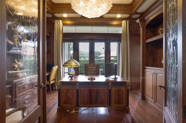 home office featuring french doors, dark wood-type flooring, coffered ceiling, an inviting chandelier, and crown molding