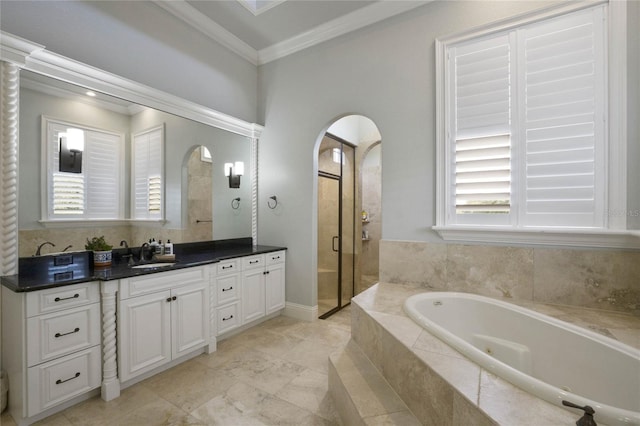 bathroom featuring independent shower and bath, vanity, crown molding, and a wealth of natural light