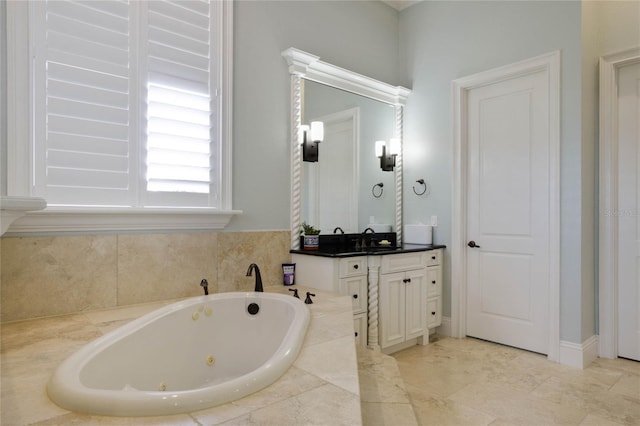 bathroom featuring tiled bath and vanity