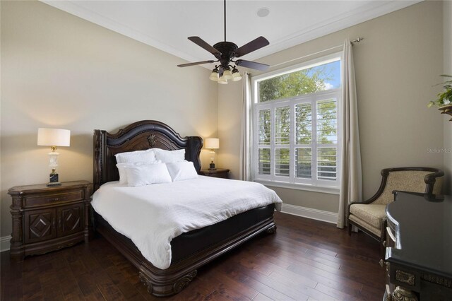 bedroom featuring ornamental molding, ceiling fan, and dark wood-type flooring