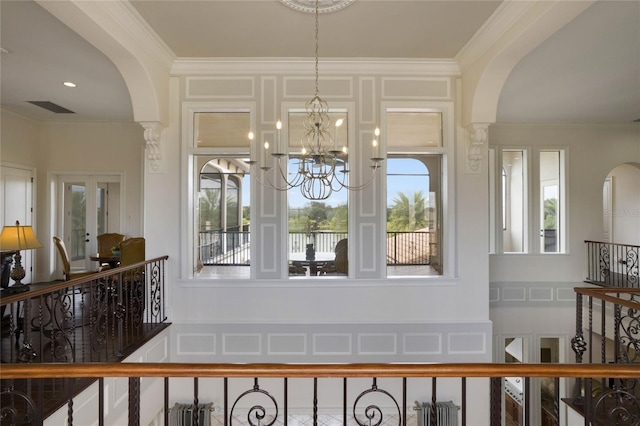 interior space featuring a notable chandelier, decorative columns, and ornamental molding