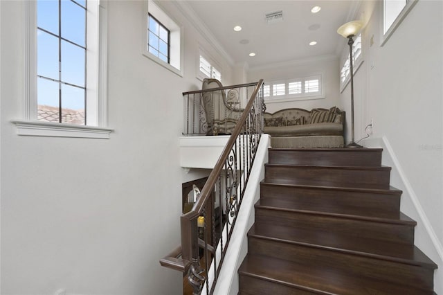 stairs featuring crown molding