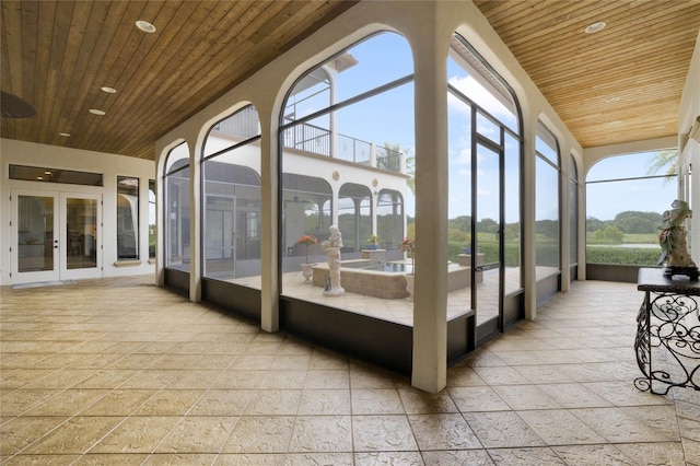 unfurnished sunroom with wood ceiling and a healthy amount of sunlight