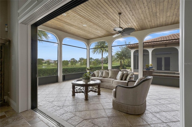 sunroom / solarium with ceiling fan and wooden ceiling