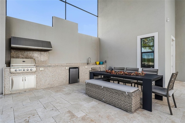 view of patio / terrace featuring exterior kitchen, sink, and a grill