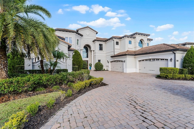 mediterranean / spanish home featuring a garage