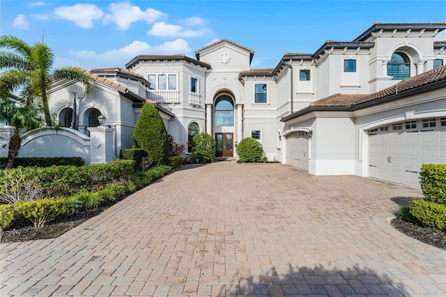 mediterranean / spanish-style house with a garage