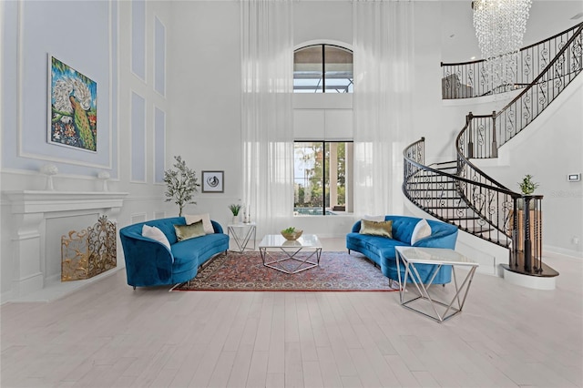 living room with a towering ceiling, hardwood / wood-style floors, and a wealth of natural light