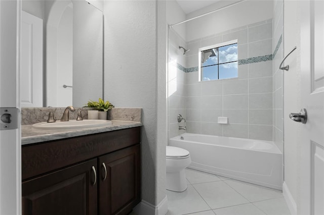 full bathroom featuring vanity, toilet, tile patterned flooring, and tiled shower / bath