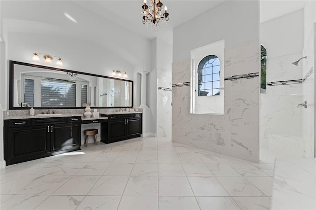 bathroom featuring vanity, tiled shower, decorative columns, and a chandelier