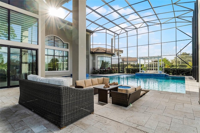 view of swimming pool with an outdoor living space, a lanai, and a patio area