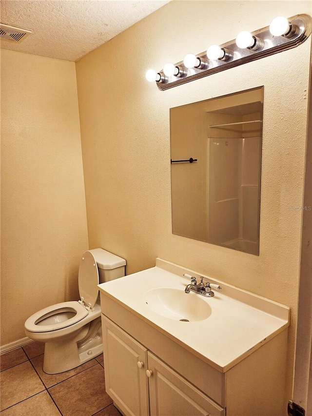 1916 Lake Atriums Cir Unit 25, Orlando, FL 32839 - bathroom with vanity, toilet, a textured ceiling, and tile patterned flooring