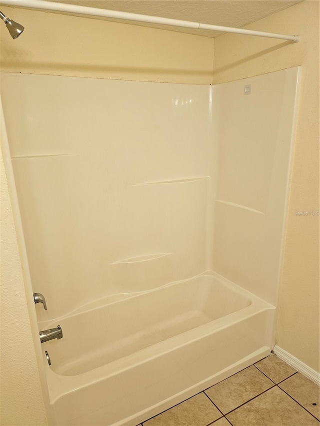 bathroom featuring bathtub / shower combination and tile patterned flooring